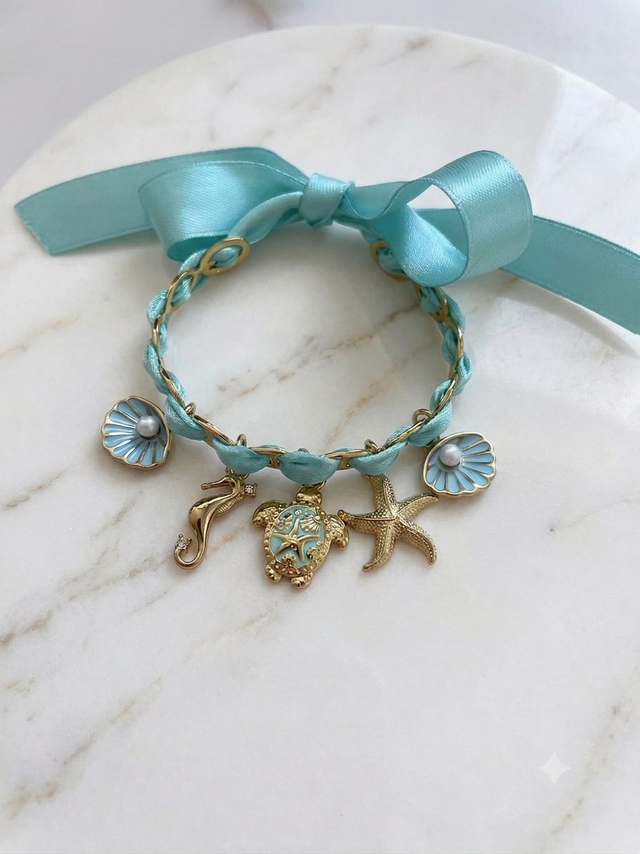 Bracelet mer turquoise en acier inoxydable avec ruban satin et breloques dorées marines