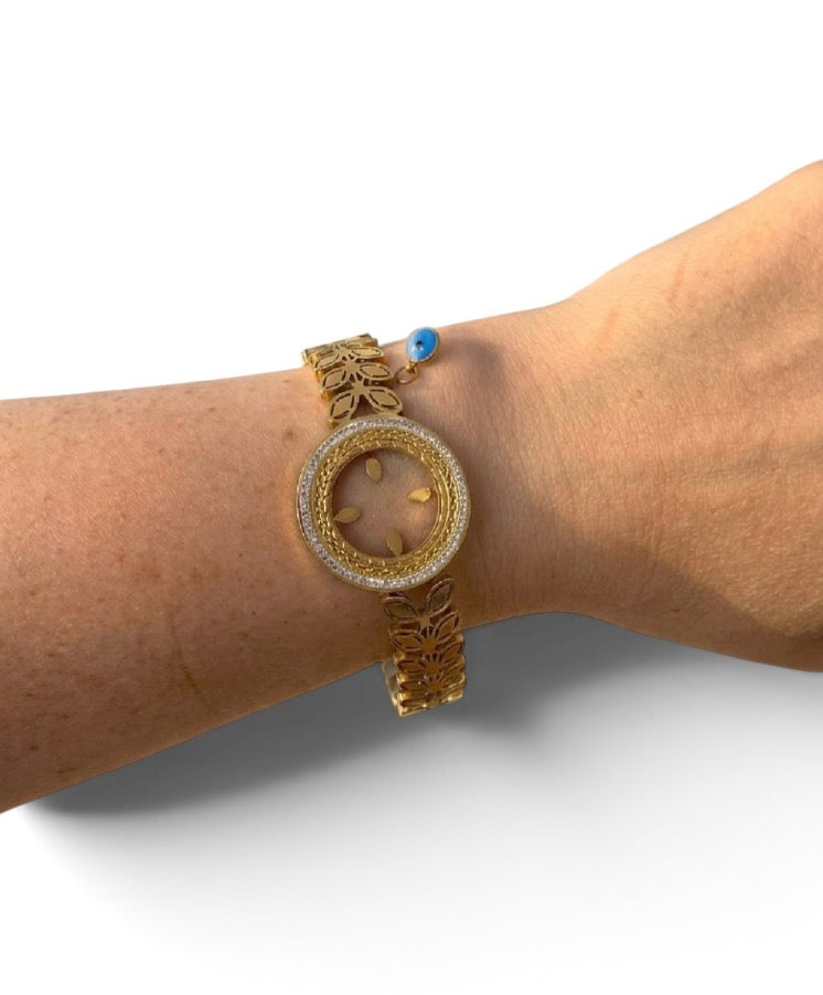 Bracelet Zohra jonc doré en acier inoxydable avec médaillon solaire et charm œil bleu 