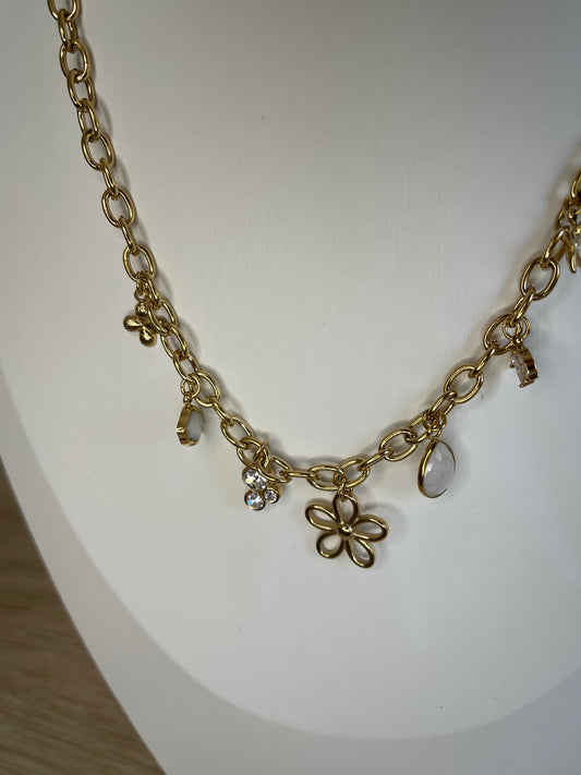 Gros plan des breloques fleurs et perles cristal du collier Paola