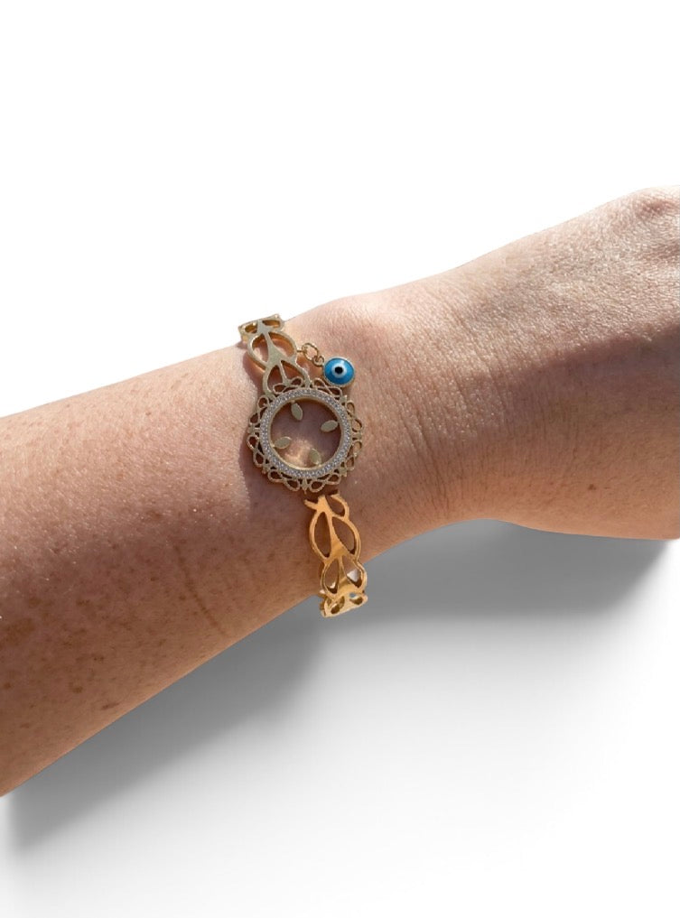 Bracelet Inova jonc doré en acier inoxydable avec charpente ajourée et amulette œil bleu 